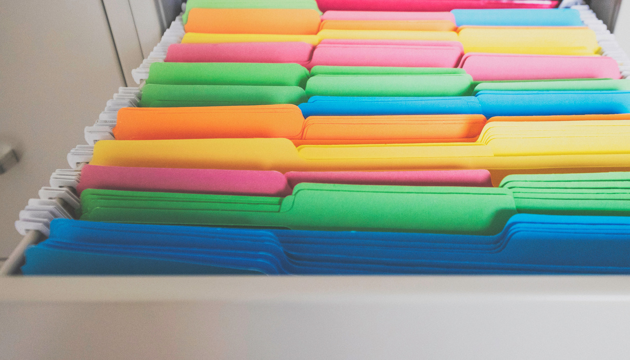 Colorful file folders in file cabinet drawer
